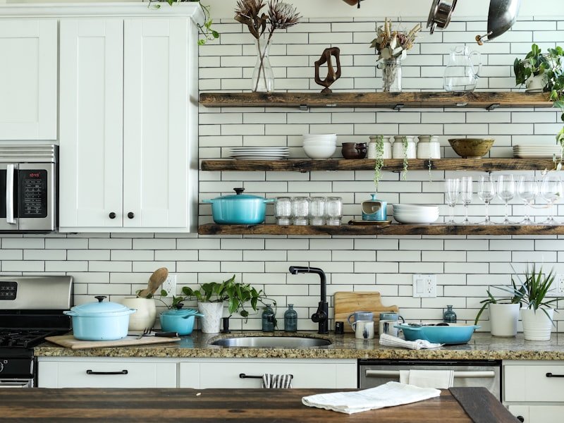 Toronto kitchen with open shelving, white tile backsplash and counter-mounted faucet