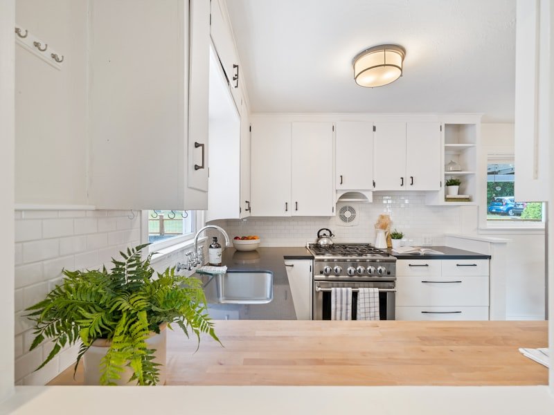 Toronto kitchen with white cabinets and a dark quartz countertop ready for replacement